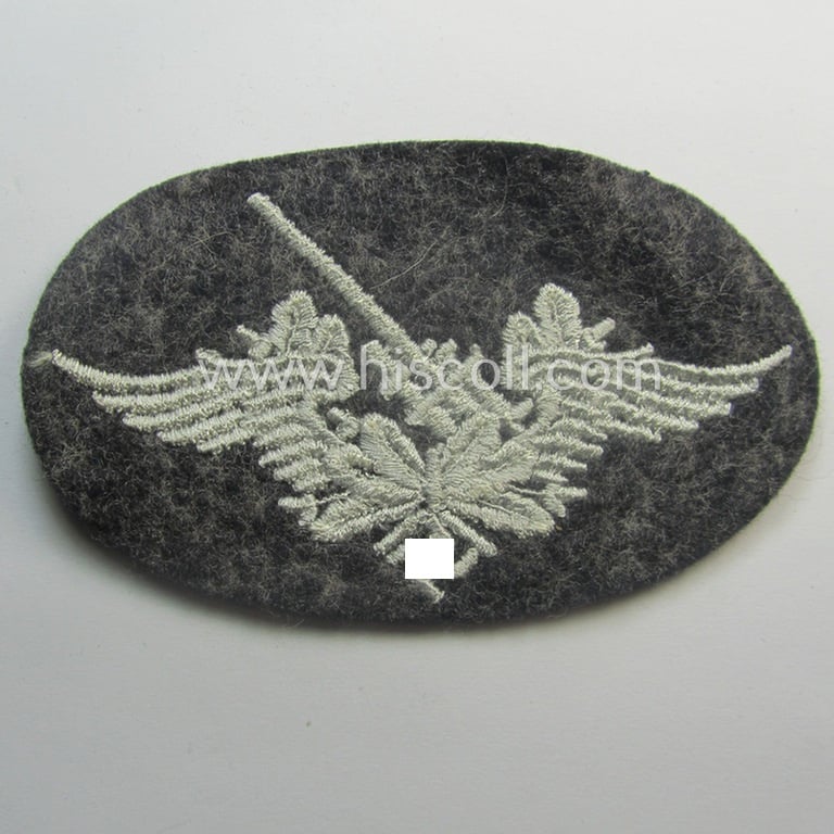 Machine-embroidered WH (Luftwaffe) trade- ie. special-career-patch as was intended for: 'Flak-Artillerie'-staffmembers and that comes in a probably issued but never worn- (ie. 'virtually mint'-), condition