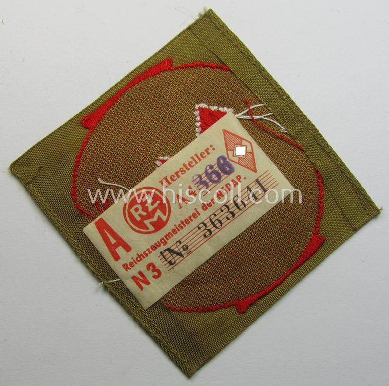 Attractive, DJ (ie. 'Deutsches Jungvolk') arm-badge as was intended for usage by a member who served within the: 'Oberbann 1' (being a 'virtually mint- ie. unissued' example that still shows its period-attached, 'RzM'-etiket)