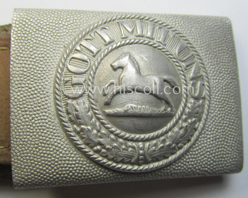 Bright-silver-coloured- and/or aluminium-based TR-period, fire-brigade- (ie. 'Feuerwehr'-) belt-buckle being a non-marked example that comes mounted onto its 'typically-shaped', leather-based tab