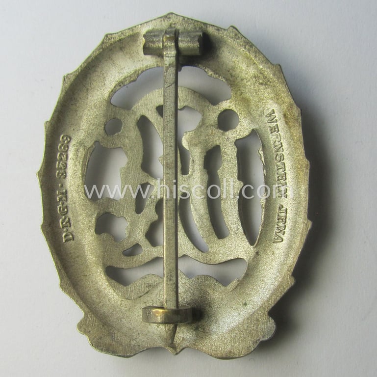 'Reichssportabzeichen DRL in Silber' (or: DRL sports'-badge in silver) being a just moderately worn- ie. used example that is nicely maker- (ie. 'Wernstein - Jena'-) marked on its back