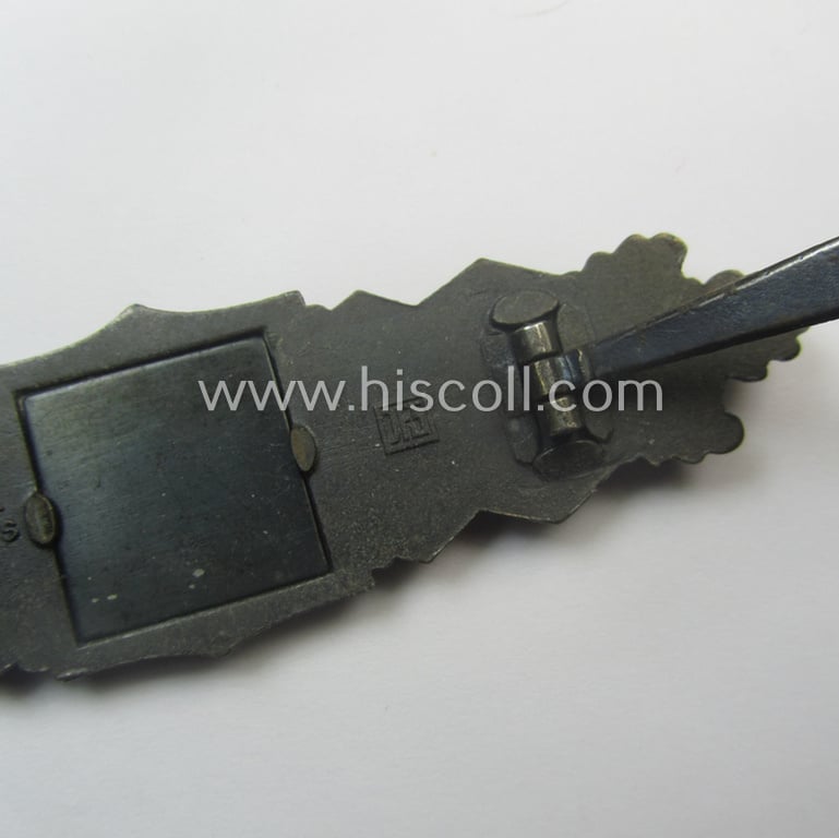 'Nahkampfspange in Bronze' (or: bronze-class close-combat clasp ie. CCC) being a neatly maker-marked- and/or minimally converse-shaped specimen as was produced by the: 'JFS'- (ie. 'Joseph Feix u. Söhne'-) company