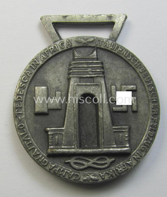 Superb, silver-coloured- (and I deem 'Feinzink'-based-) example of a: 'Deutsch-Italienische Feldzugsmedaille' (or: German-Italian campaign medal) that came together with its (regular-sized) piece of original ribbon