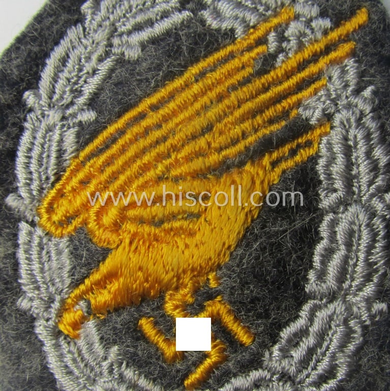 WH (Luftwaffe) 'Fallschirmschützen-Abzeichen in Stoff' (or: cloth-based paratroopers' jump-badge) that is nicely machine-embroidered and being of the so-called: 'padded version'