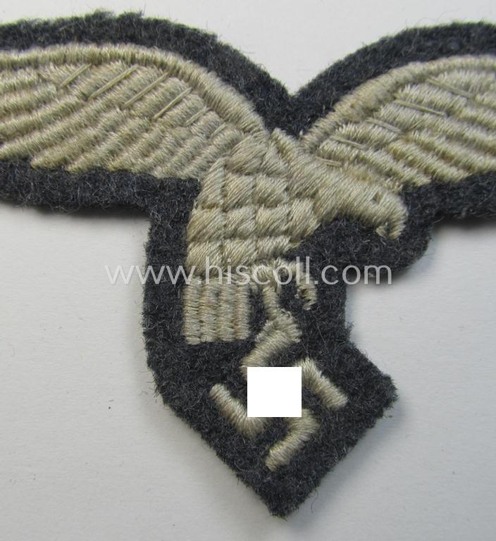 Superb, moderately used- and/or tunic-removed, WH (Luftwaffe) EM- (ie NCO-) pattern, machine-embroidered breast-eagle (showing a 'down-tailed'-eagle and being an early- ie. pre-war-period example) that comes in a moderately used-, condition