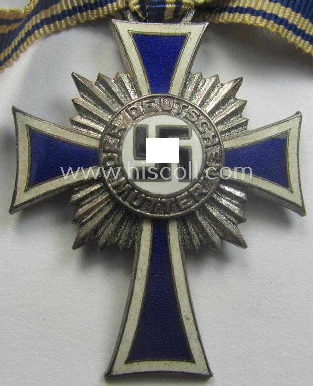 'Ehrenkreuz der deutschen Mutter - zweite Stufe' (or: silver-class mothers'-cross) that came mounted onto its (unusally seen!) 'bow-shaped' ribbon as issued and recently found