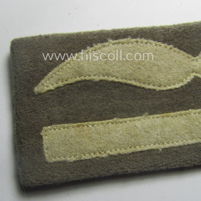 Single, WH (Luftwaffe) greyish-blue-coloured, officers'-type rank-patch (aka 'moustache'), as was intended for usage by a commissioned officer with the rank of: 'Leutnant' (ie. lieutnant)