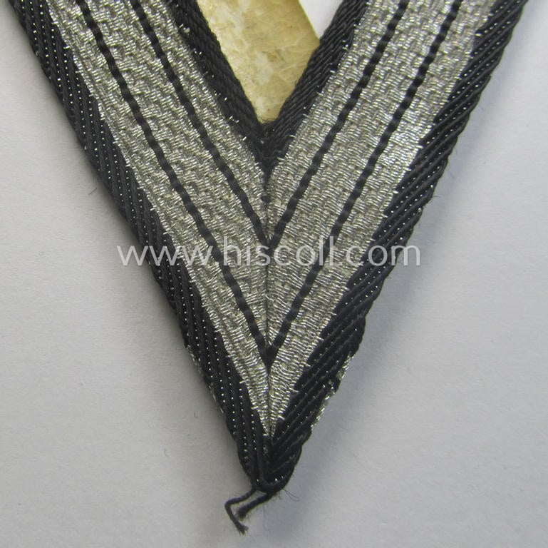 SS (ie. 'Allgemeine o. Waffen-SS') arm-insignia being an 'SS', so-called: 'Ehrenwinkel für Altgediente Kämpfer o. Angehörigen der SS' (or: honorary-chevron for old campaigners) still retaining its period 'RzM'-etiket