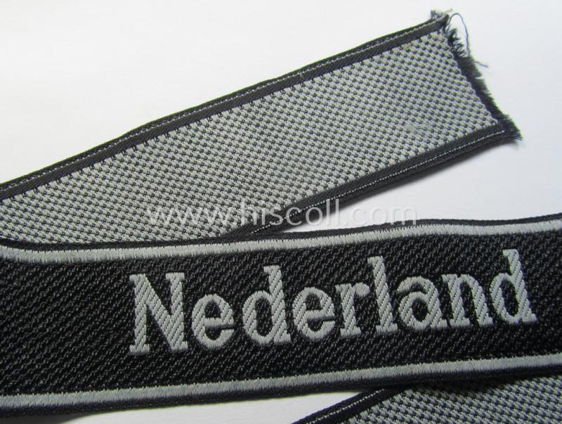 Superb, Waffen-SS, 1943/44 pattern cuff-title (ie. 'Ärmelstreifen') depicting the machine-woven Latin script text in silver-grey linnen as was intended for a member serving within the: '23. SS Freiwilligen Panzer Grenadier Division' ('Nederland...