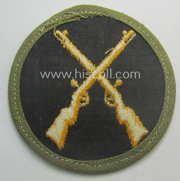 WH (Heeres) 'tropical'-issued, trade- and/or special-career insignia (ie. machine-embroidered 'Laufbahn- o. Tätigkeitsabzeichen') as was intended for an army: 'Waffenmeister' (or: weapon-equipment NCO)