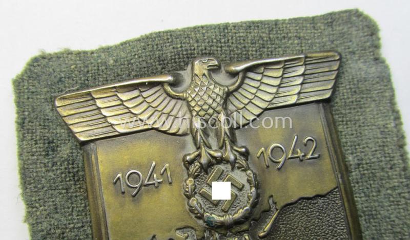 Superb, WH (Heeres o. Waffen-SS) 'Krim'-campaign-shield that comes mounted onto its original, field-grey-coloured 'backing' and that comes in a surely issued-, minimally worn and/or (I deem) carefully tunic-removed-, condition