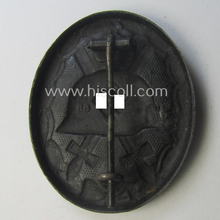 Moderately used and/or neatly maker- (ie. '88'-) marked example of a black-class wound-badge (or: 'Verwundeten-Abzeichen in Schwarz') being an example that was produced by the desirable maker (ie. 'Hersteller') named: 'Werner Redo'