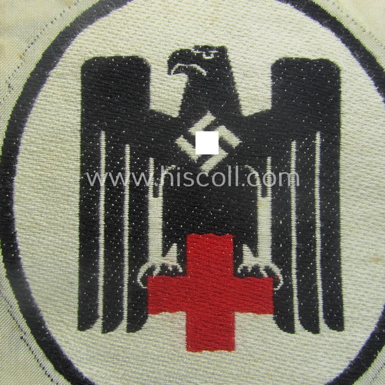 DRK- (ie. 'Deutsches Rotes Kreuz'-) related sport-shirt emblem as was executed in the neat 'BeVo'-weave-pattern and that comes in a 'virtually mint' condition
