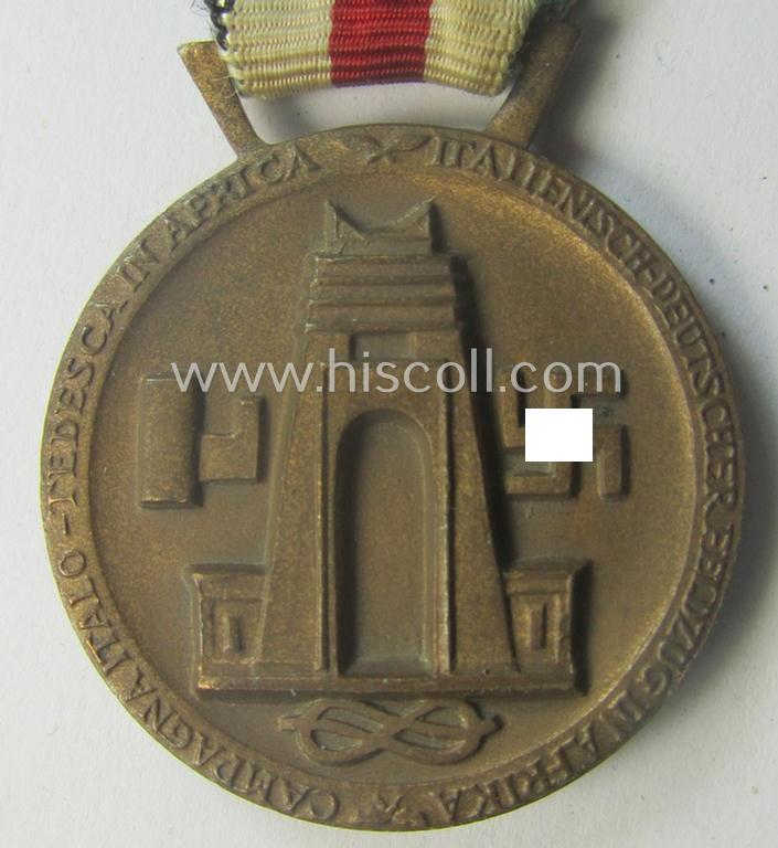 Golden-bronze-coloured example of a: 'Deutsch-Italienische Feldzugsmedaille' (or: German-Italian campaign-medal) that comes mounted onto its (regular-sized) piece of original (and minimally faded- ie. stained!) ribbon