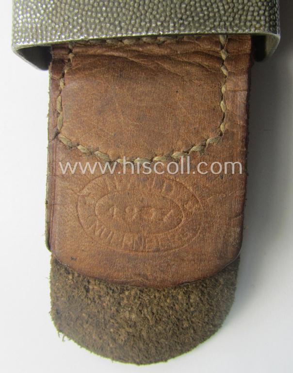 WH (Heeres) 'standard-pattern', field-grey-toned- and aluminium-based belt-buckle being a maker- (ie. 'H. Arld - Nuernberg'-) marked- and/or: '1937'-dated example that comes mounted onto its leather-based tab