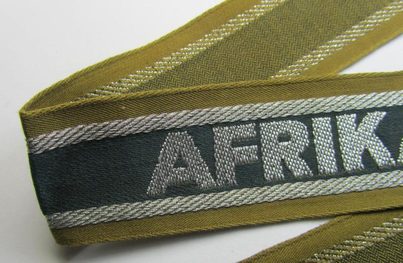 Superb, 'BeVo'-like cuff-title (ie. 'Ärmelstreifen') entitled: 'Afrikakorps' being a presumably issued but never worn example that comes in an overall very nice- (ie. non-shortened- and never tunic-attached-), condition