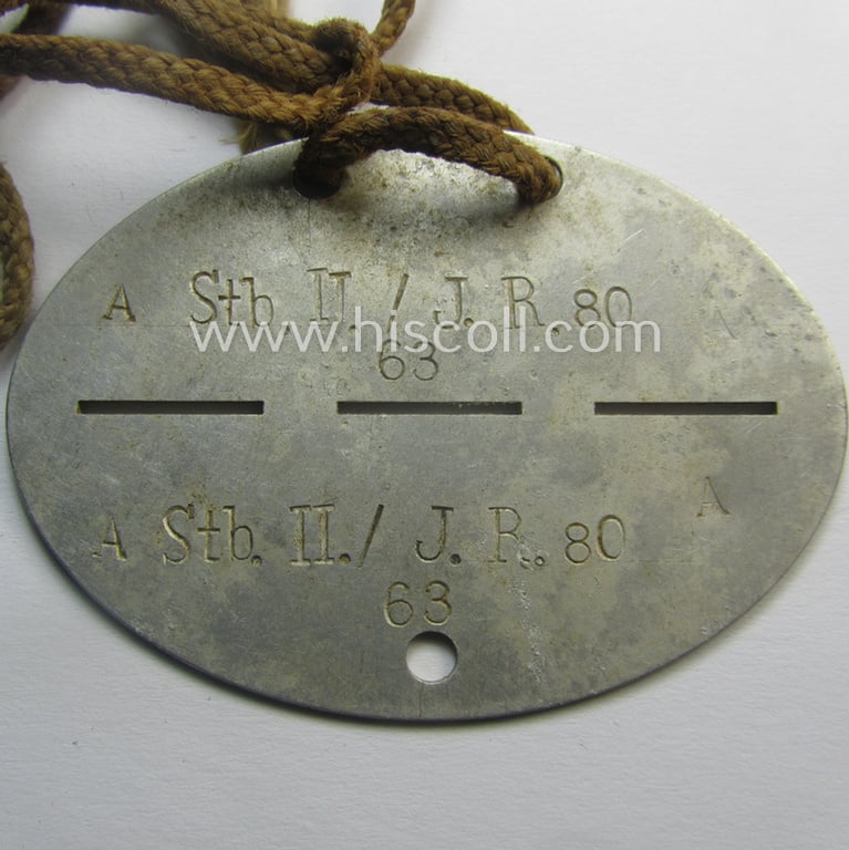 Aluminium-based, WH (Heeres) (ie. 'Infanterie'-related) ID-disc bearing the clearly stamped unit-designation that reads: 'Stb. II./J.R. 80' and that comes mounted onto its (period-attached) cord