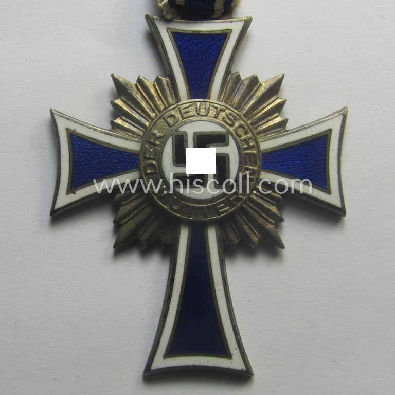 'Ehrenkreuz der deutschen Mutter - zweite Stufe' (or: silver-class mothers'-cross) that came mounted onto its long-sized ribbon and that came stored in its period pouch by the maker: 'Gottlieb & Wagner - Oberstein/Nahe'