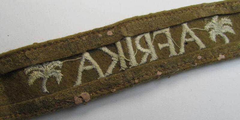 Attractive, WH (LW o. Heeres) cuff-title (ie. 'Ärmelstreifen') entitled: 'Afrika' (being a period-shortened- and woolen-based example that comes in a clearly issued- and/or worn condition)