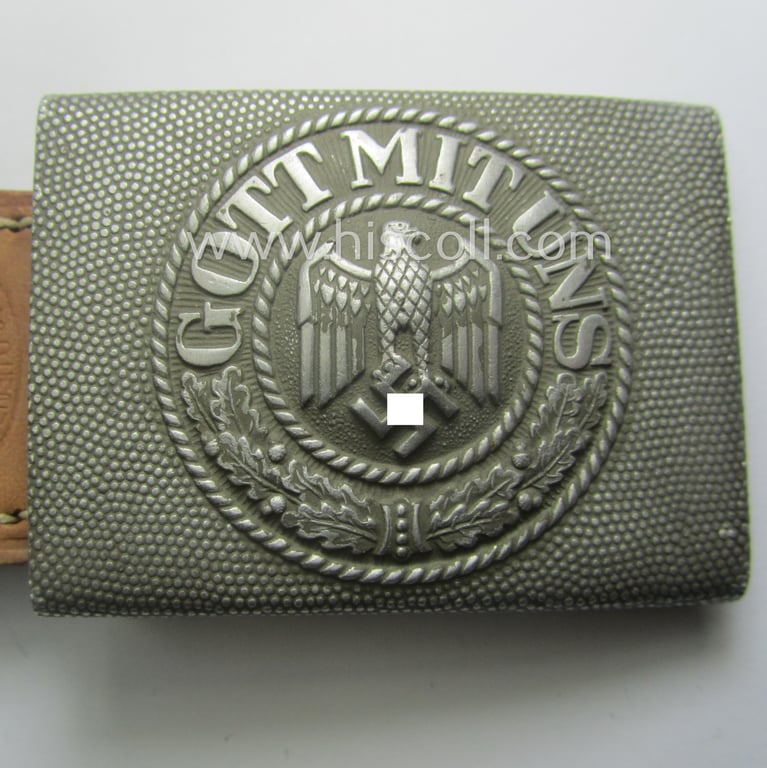 WH (Heeres) 'standard-pattern', field-grey-toned- and aluminium-based belt-buckle being a maker- (ie. 'Steinhauer & Lück'-) marked- and/or: '1939'-dated example that comes mounted onto its leather-based tab