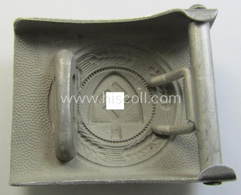 Superb, aluminium-based: 'Reichsarbeitsdienst'- (ie. RAD-) EM- (ie. NCO-) type belt-buckle being a maker- (ie. 'F.W. Assmann u. Söhne'-) marked example which is dated: '1938' and that comes in a simply never used- (ie. 'virtually mint'-) cond...