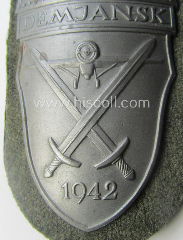 Superb, WH (Heeres ie. Waffen-SS) 'Demjansk'-campaign-shield as executed in typical magnetic metal (ie. so-called: 'Eisenblech') and that comes in an overall very nice- ie. fully untouched-, condition