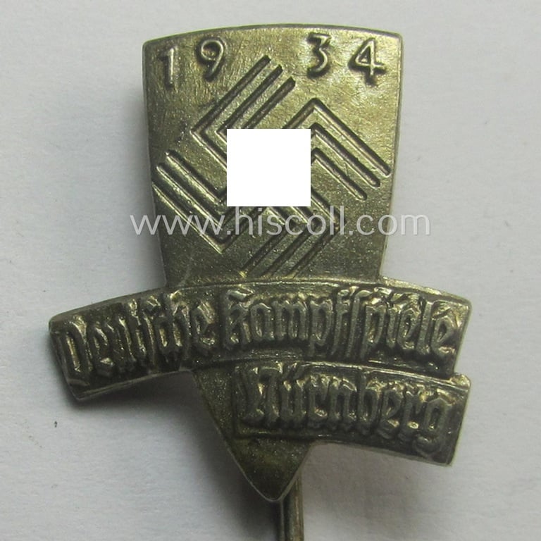 Commemorative lapel-pin (ie. 'Veranstaltungsabzeichen') being a maker- (ie. 'Balmberger-Nürnb.'-) marked example depicting a swastika-device coupled with the text: 'Deutsche Kampfspiele - Nürnberg - 1934'