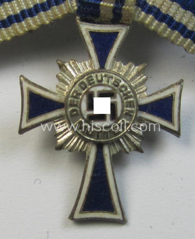 Miniature of an: 'Ehrenkreuz der deutschen Mutter - zweite Stufe' (or: silver-class mothers'-cross) being a non-maker-marked example that comes in an overall nice- (albeit moderately worn- ie. used-), condition