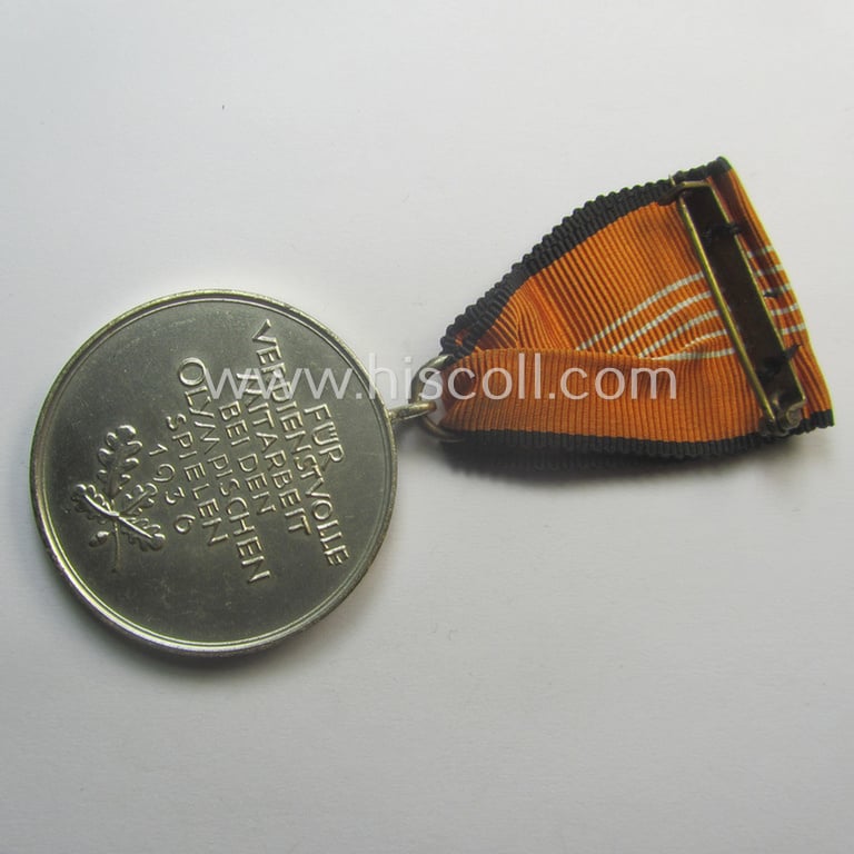 'Deutsche Olympia-Erinnerungsmedaille 1936' being a non-maker-marked example that comes mounted onto its original ribbon (ie. 'Bandabschnitt')