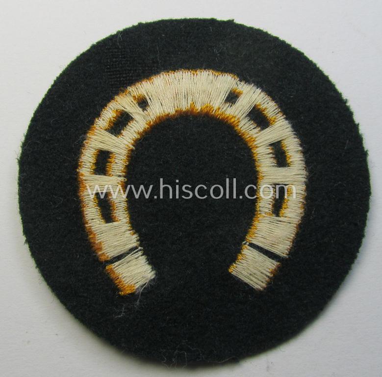 WH (Heeres) so-called trade- and/or special-career arm-patch as specifically intended for a: 'Hufbeschlagmeister' (or: farrier) being a neatly machine-embroidered 'variant' as executed on darker-green-coloured wool