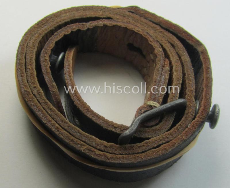 Later-war-period- and 'standard-issue'-pattern, black-coloured- and/or leather-based WH helmet-strap (ie. 'Riemen für Stahlhelm') being an: 'HCH 4'-marked example that comes in a never mounted ie. 'virtually mint' condition