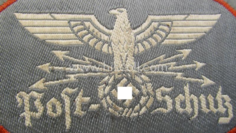 Superb, 'Post-Schutz' arm-badge (ie. arm-eagle) being a piece as executed in the 'BeVo'-weave-pattern - and showing a seldomly seen orange-coloured 'rim'! - and that comes in a 'virtually mint- ie. unissued', condition