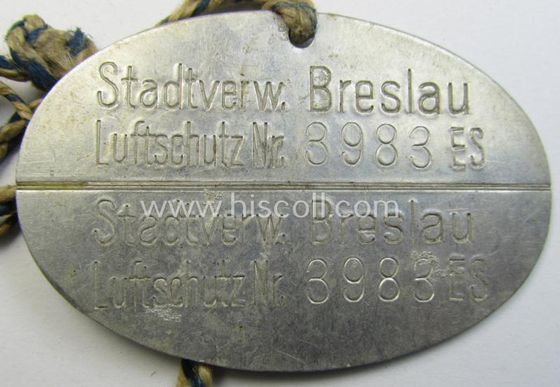 Very unusual, aluminium-based RLB- (ie. 'Reichs-Luftschutzbund'-) related ID-disc bearing the clearly stamped unit-designation that simply reads: 'Stadtsverw. Breslau - Luftschutz Nr. 3983 ES' and that comes mounted onto  its period cord