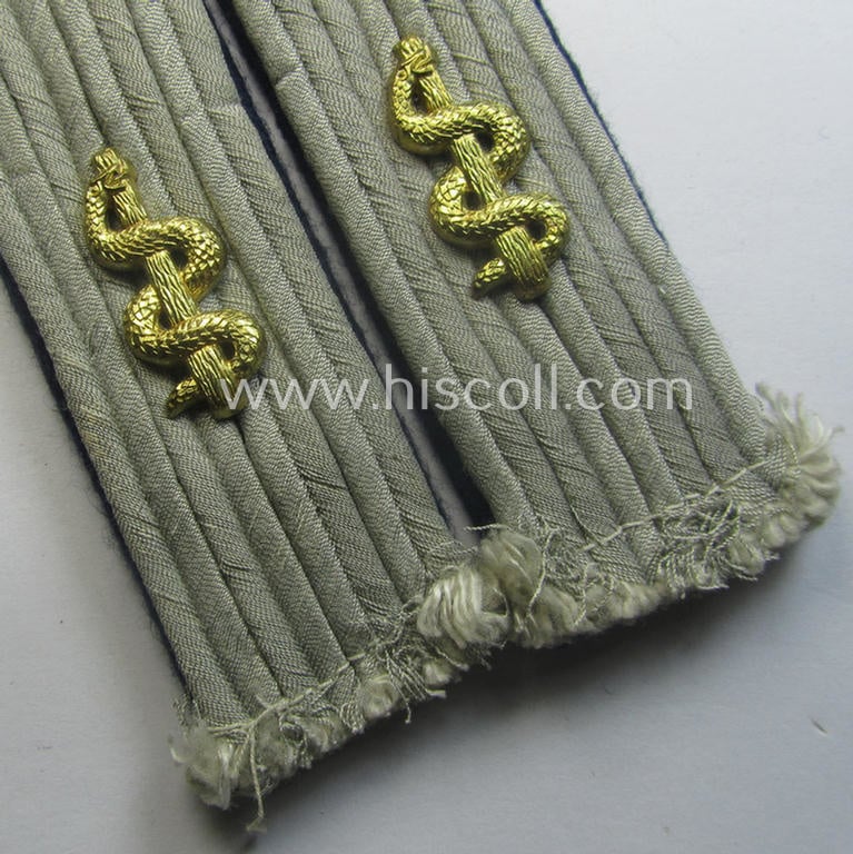 Pair of 'cyphered', WH (Heeres) officers'-pattern shoulderboards as piped in the darker-blue-toned branchcolour as was specifically intended for a: 'Leutnant u. Arzt einer Sanitäts-Abtlgs.'