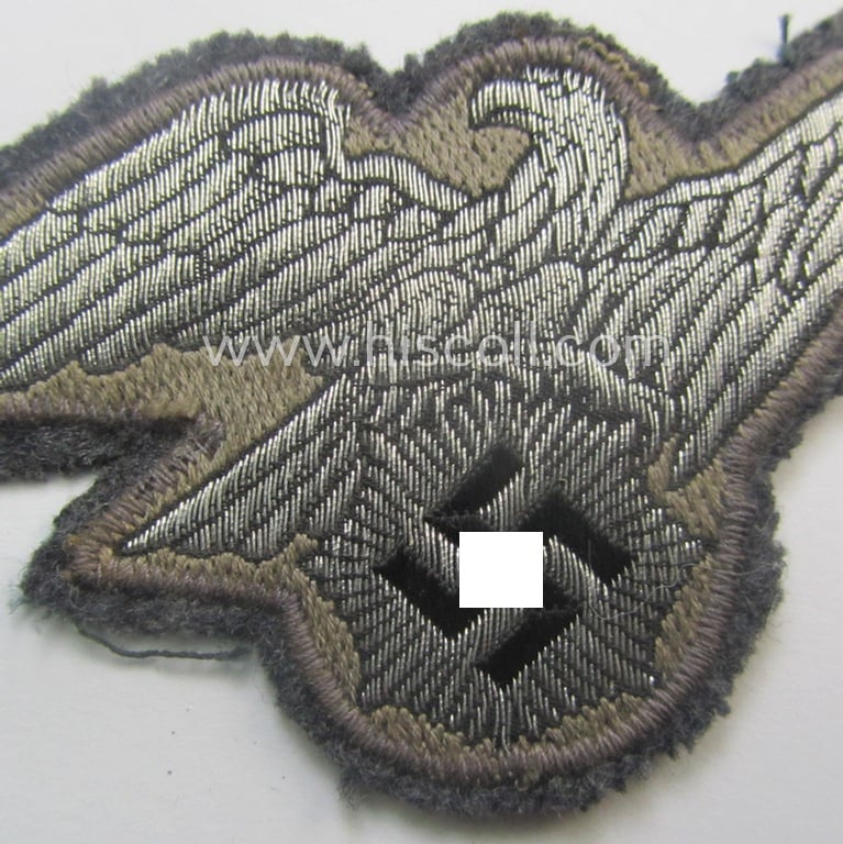 Moderately used, officers'-pattern, 'Luftschutz' (ie. RLB-) breasteagle being a neatly 'BeVo'-flat-wire'-woven example that is executed onto a bluish-grey-coloured- and/or woolen-based background