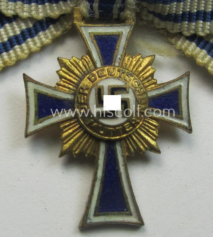 Miniature of an: 'Ehrenkreuz der deutschen Mutter - erste Stufe' (or: golden-class mothers'-cross) being a non-maker-marked example that comes in an overall nice- (albeit moderately worn- ie. used-), condition