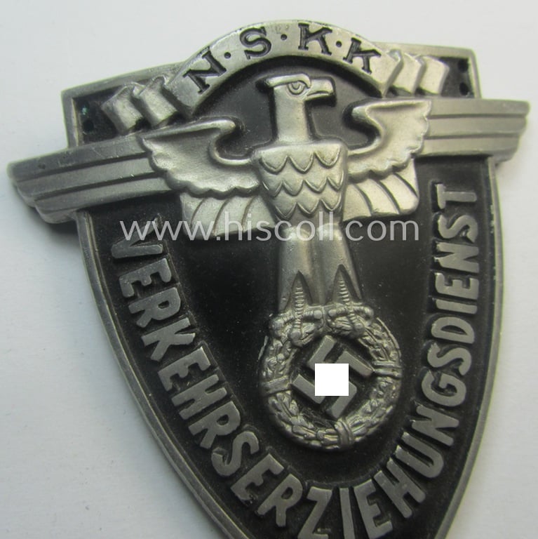Superb - quite rarely seen and very detailed! - aluminium-based, N.S.K.K.-related armshield (ie. 'Ärmelshield') depicting the typical N.S.K.K.-eagle-device and text that reads: 'Verkehrserziehungsdienst'
