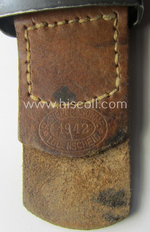 WH (Luftwaffe) darker-blue-coloured- and/or steel-based belt-buckle, being a neatly maker- (ie. 'R. Sieper & Söhne'-) marked and/or: '1942'-dated example that comes mounted onto its period, natural-coloured and/or leather-based tab