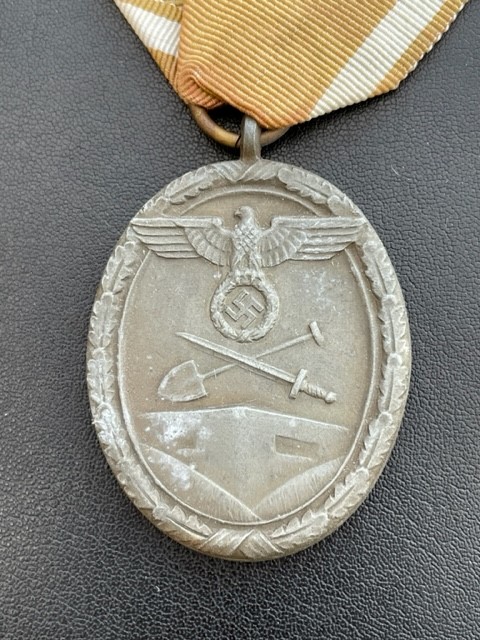 WWII GERMAN WEST WALL MEDAL WITH PAPER ISSUE PACKET.