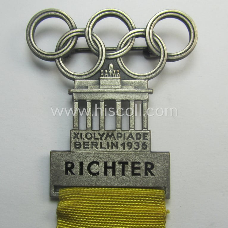 Stunning - and actually never before seen! - 'Richter-Abzeichen' being a maker- (ie. 'L.Chr. Laurer'-) marked example that is showing the Olympic-rings above an illustration of the: 'Reichstag' coupled with a yellow ribbon showing the text: 'Ringen'