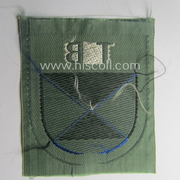 Eastern- (ie. Russian) volunteer (ie. Cossack-) related armshield as executed in the neat 'BeVo'-weave pattern depicting the interwoven 'Cyrillic' characters: 'TB' (as was intended for the Russian volunteers serving within the 'Terek Cossacks')