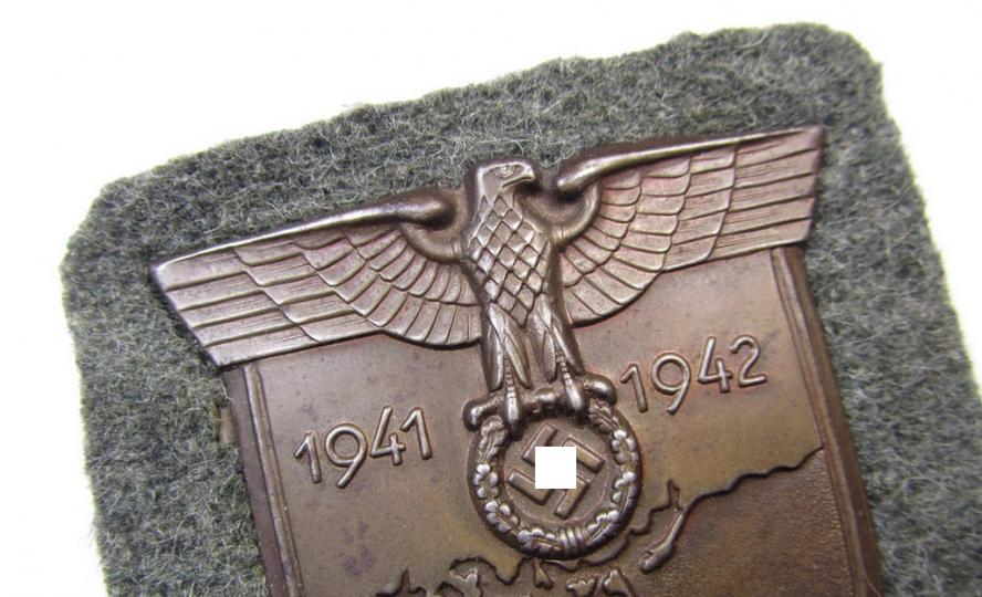 Attractive, WH (Heeres ie. Waffen-SS) 'Krim'-campaign-shield that comes mounted onto its original, field-grey-coloured 'backing' and that comes in a moderately used- and/or tunic-removed, condition