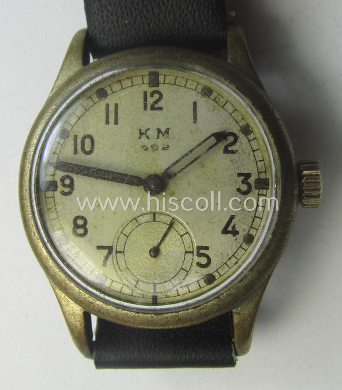 WH (Kriegsmarine) WWII-period wrist-watch (or: 'Dienstuhr') of the make: 'K.M. - 592' having a beige-white-coloured dial-plate and neatly engraved number on its back that reads: '328721'