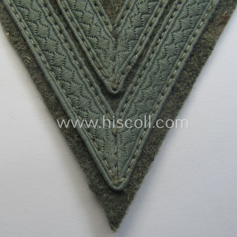 WH (Heeres) 'Armwinkel' (or: arm-chevron) as executed on typical field-grey-coloured wool as was specifically intended for usage by a soldier with the rank of: 'Obergefreiter'