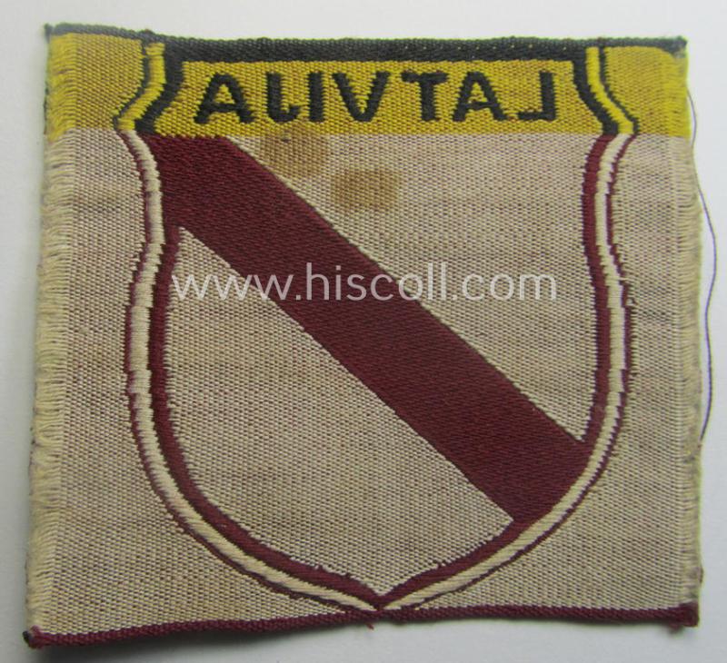 Locally produced(!), 'Waffen-SS'-type armshield as executed in the so-called: 'semi-BeVo'-pattern entitled: 'Latvia' as was merely intended for usage by the members of the: 'Latvian Legion'