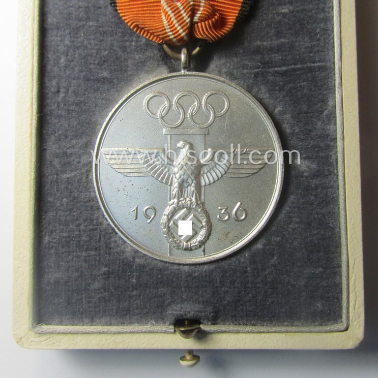 Superb, 'Deutsche Olympia-Erinnerungsmedaille 1936' being a non-maker-marked example that comes mounted onto its original ribbon (ie. 'Bandabschnitt') and that comes stored in its typical, beige-white-coloured etui