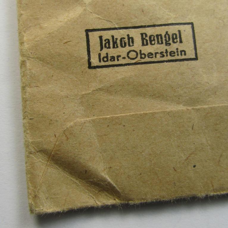 Attractive, 'Ehrenkreuz der deutschen Mutter - dritte Stufe' (or: bronze-class mothers'-cross) that came mounted onto its long-sized ribbon and that came stored in its period pouch (by the maker: 'Jakob Bengel - Idar-Oberstein')