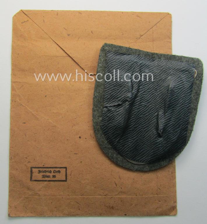 WH (Heeres ie. Waffen-SS) 'Krim'-campaign-shield (by the maker: 'Friedrich Orth') that comes stored in its period (and rarely seen!) 'Zellstoff'-based pouch and that comes in a probably issued- (albeit still 'virtually mint'-), condition