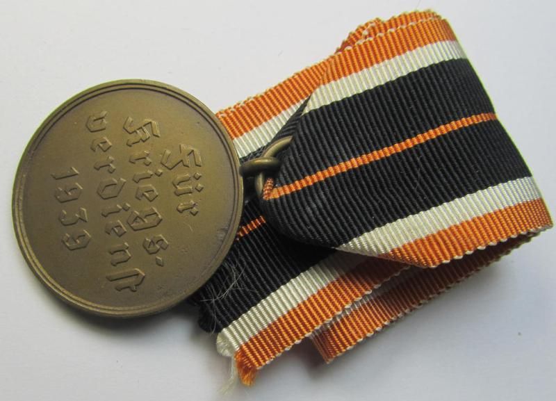 Attractive 'Kriegsverdienstmedaille 1939' being a non-maker-marked- (and/or: 'Buntmetall'-based) specimen that came mounted onto its (orange-coloured- and truly long-sized!) ribbon (ie. 'Bandabschnitt')