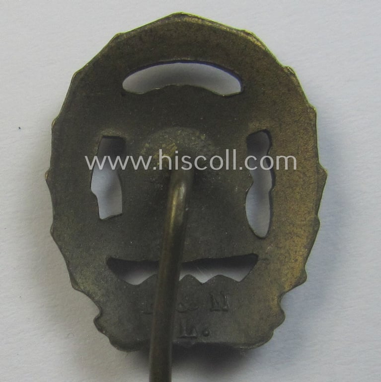 'Reichssportabzeichen DRL in Bronze' (or: bronze class DRL sports'-badge) being a maker- (ie. 'Ernst L. Müller'-) marked and that comes with its accompanying miniature