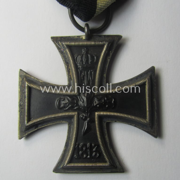 WWI-period: 'Eisernes Kreuz II. Klasse' being a typical maker- (ie. 'K.A.G.'-) marked example that comes mounted onto an unusually confectioned ribbon